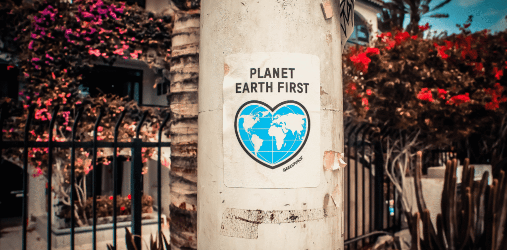 sign on post that says "Plant Earth First"